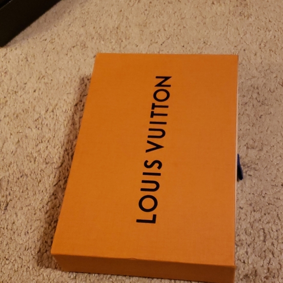 Louis Vuitton box with ribbons.
